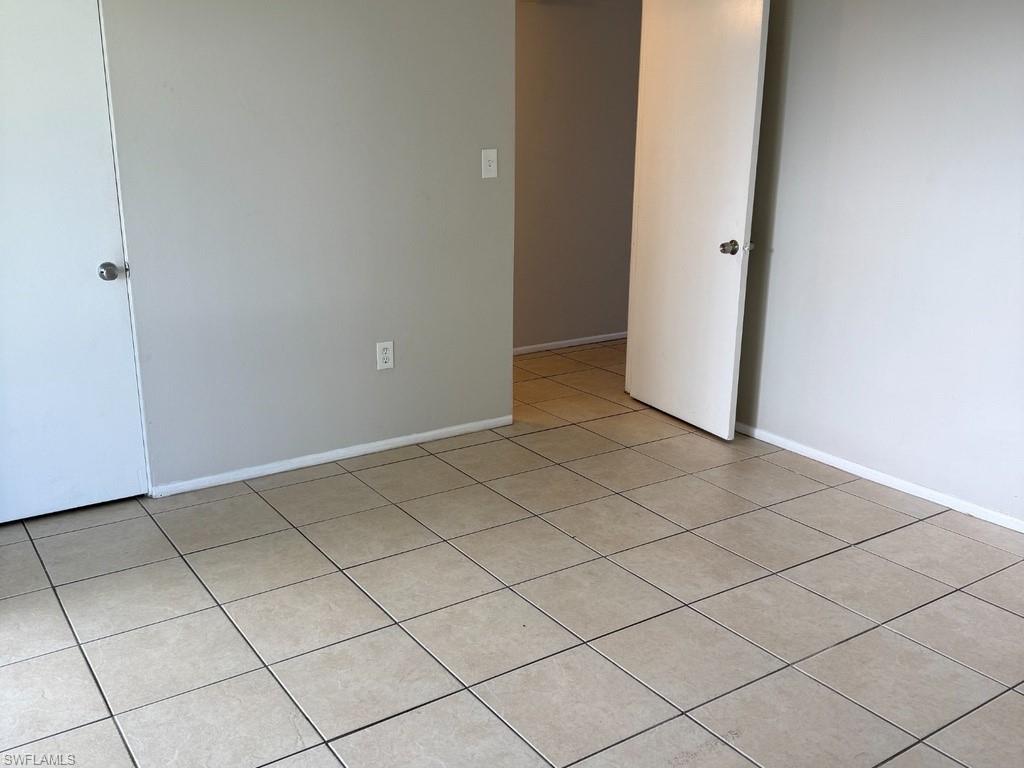 Neutral-toned tile flooring, light gray wall paint, and white trim