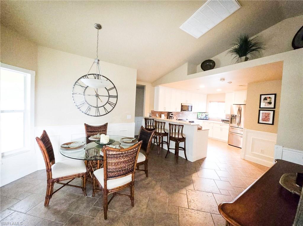 Tiled flooring, wainscoting, and multiple windows for abundant natural light