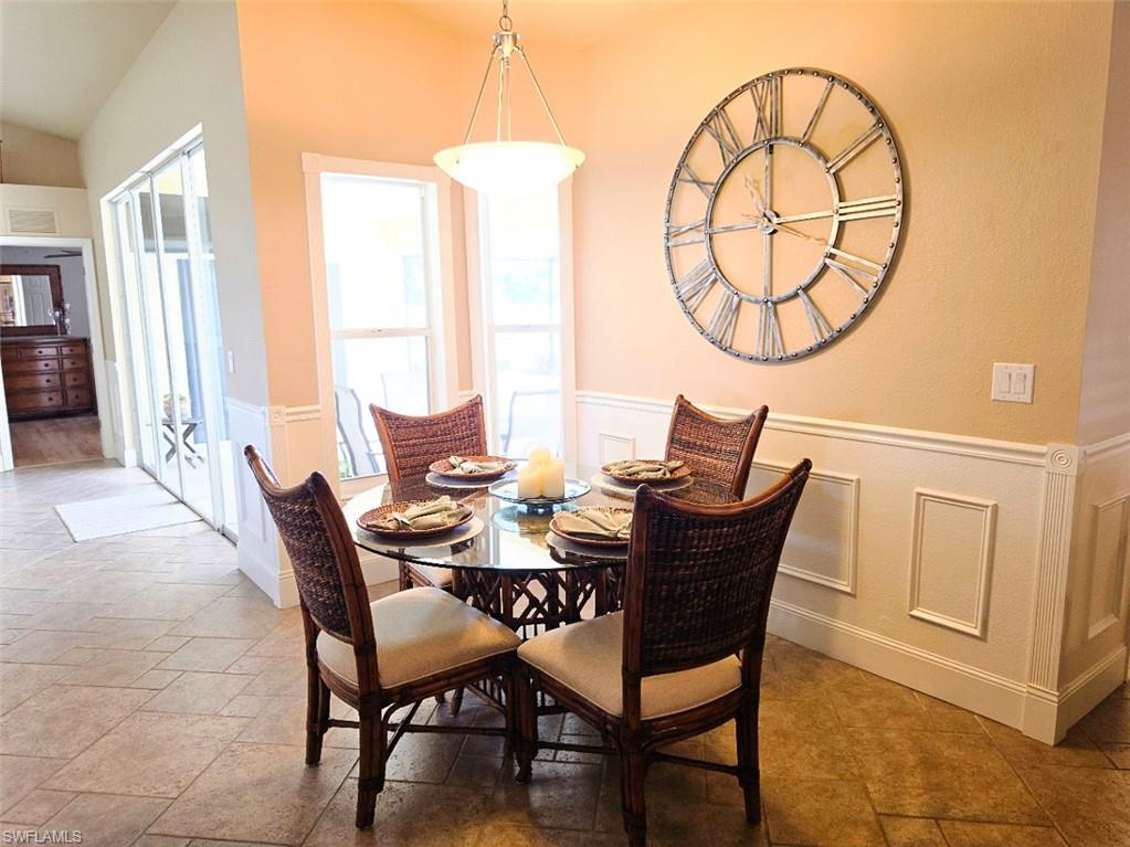 Tiled flooring, wainscoting, and multiple windows for abundant natural light