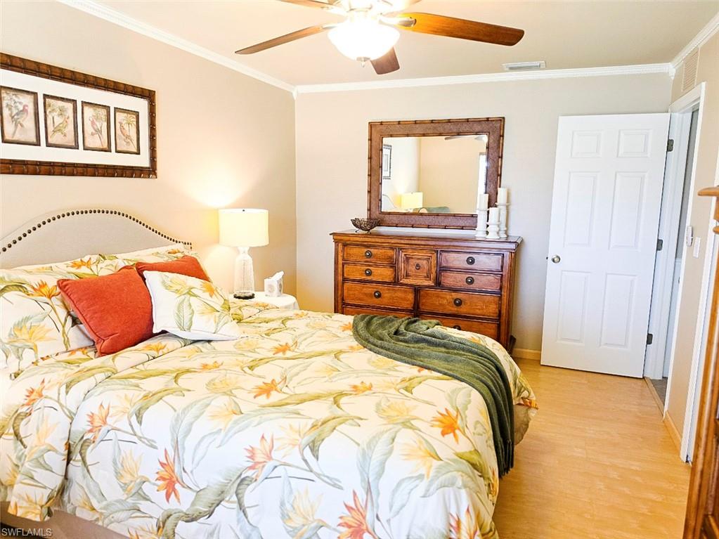 Light wood-finish flooring with a multi-paneled interior door