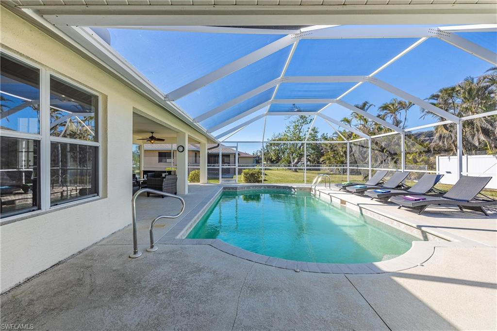Outdoor pool with glass enclosure and a patio area