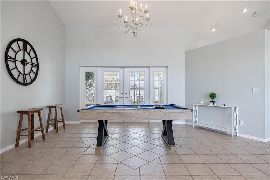 Recreation room with an inviting chandelier, billiards, and light tile patterned floors