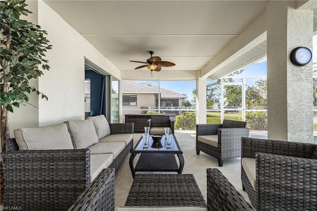 View of patio with outdoor lounge area and ceiling fan
