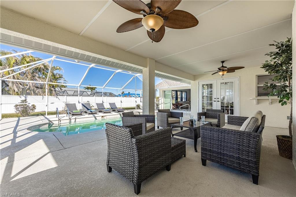 View of patio featuring a fenced in pool, a ceiling fan, fence, french doors, and an outdoor living space