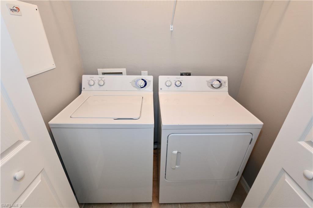 Dedicated laundry area with a top-load washer and front-load dryer