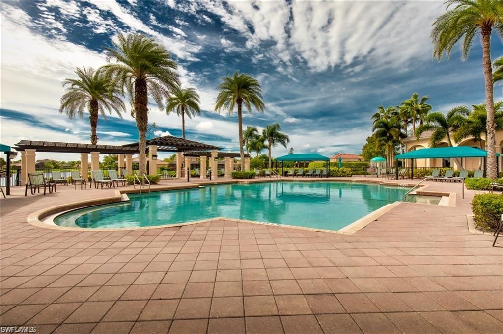 Expansive swimming pool with integrated spa, surrounded by a paver deck