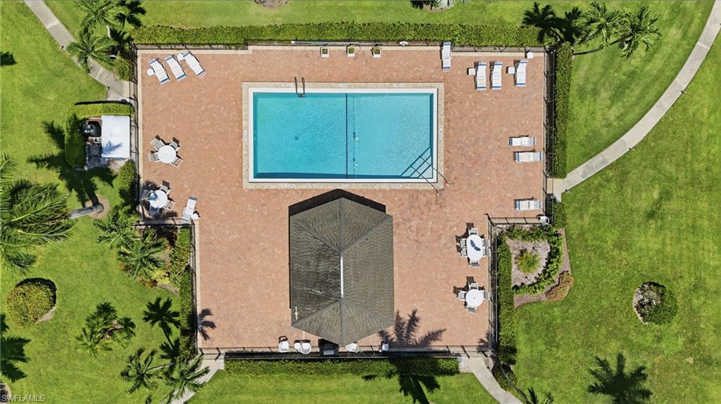 Rectangular swimming pool surrounded by a brick-finish deck