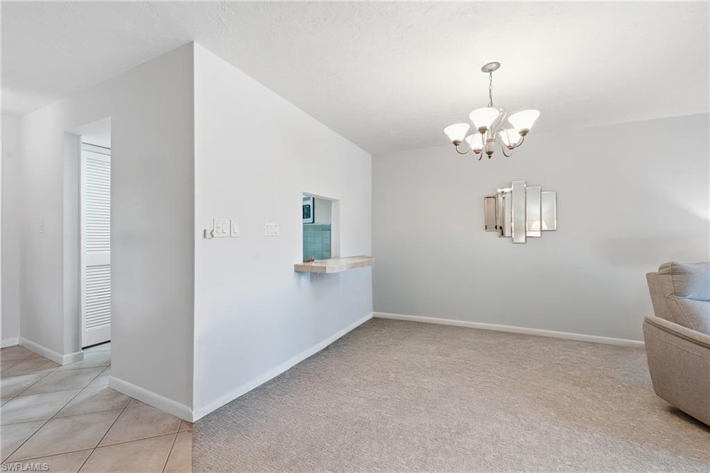 Dining area off the kitchen pass through, anchored by a chandelier