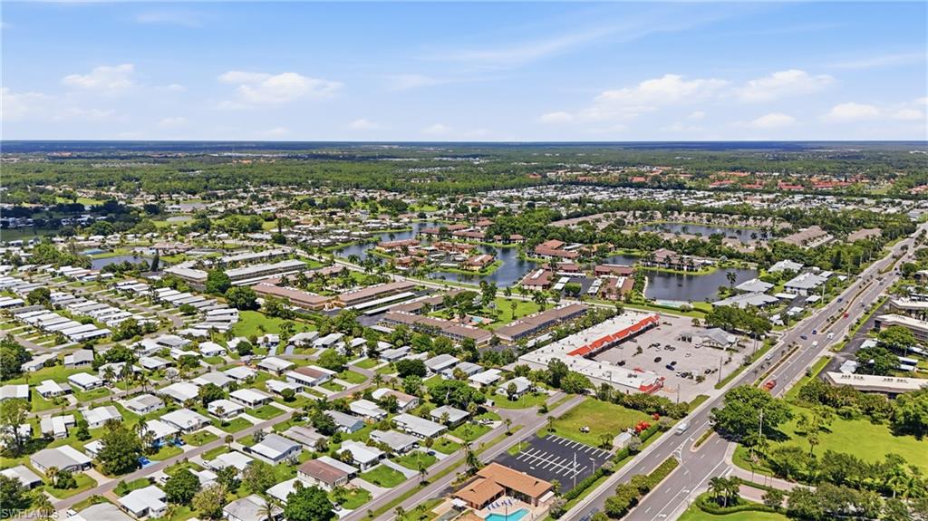 Additional contenAerial perspective showcasing residential developments, lush green spaces, and a prominent golf courset
