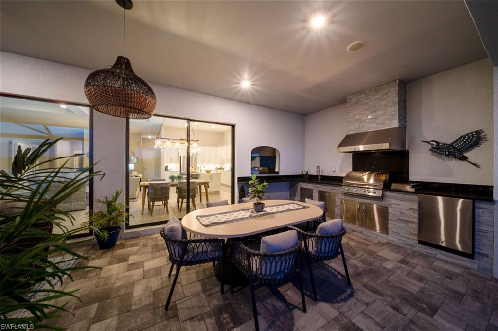 rear covered outdoor entertaining area with full outdoor kitchen with gas grill