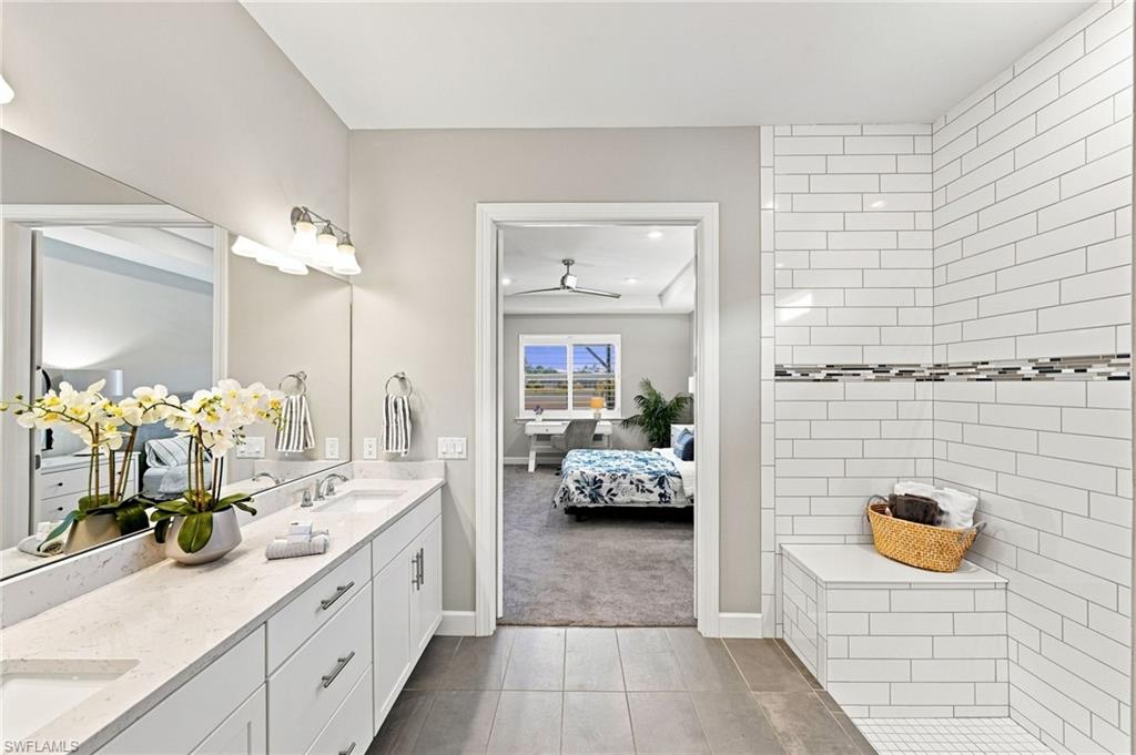large primary bath with dual sink vanity, large walk in shower