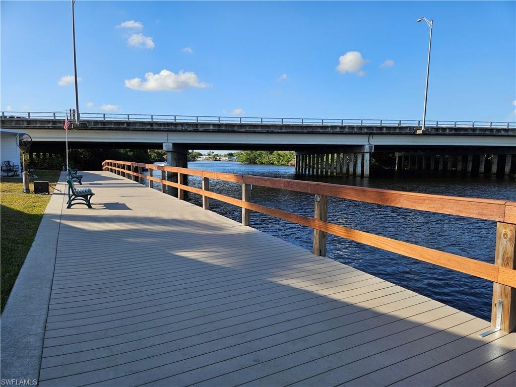 Waterfront boardwalk featuring a composite deck and natural wood railings