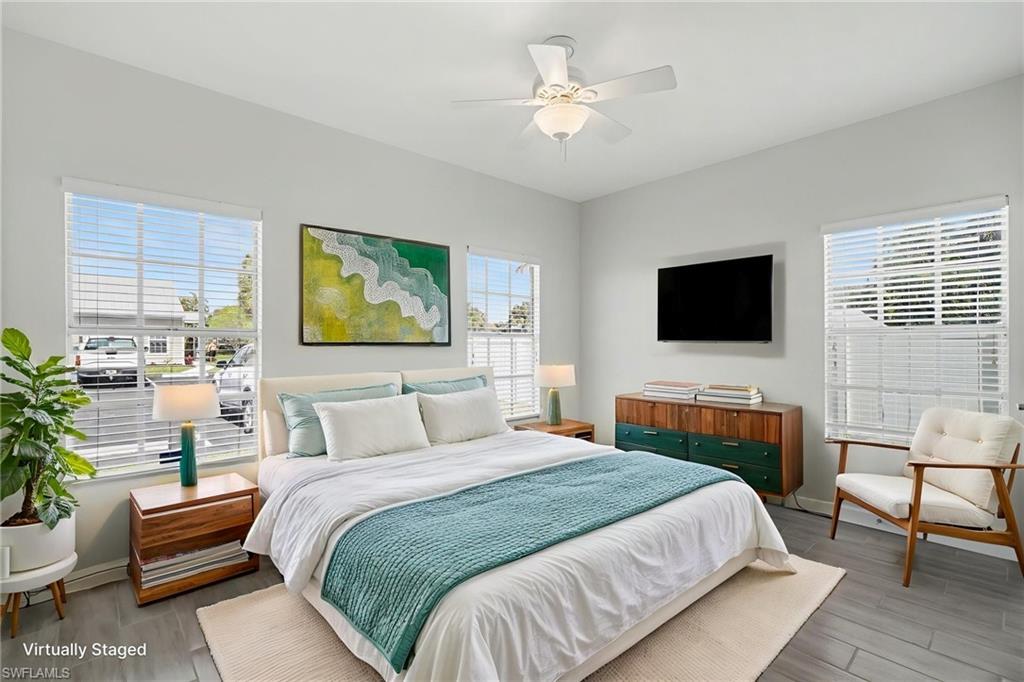 Virtual Staged Recessed lighting, ceiling fan with integrated lighting, wood-finish flooring, multiple windows with blinds, and light-toned wall finishes