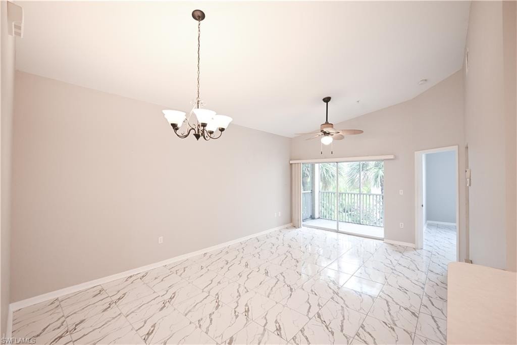 Vaulted ceilings with a decorative chandelier, tile flooring, sliding glass doors to a balcony, and a ceiling fan