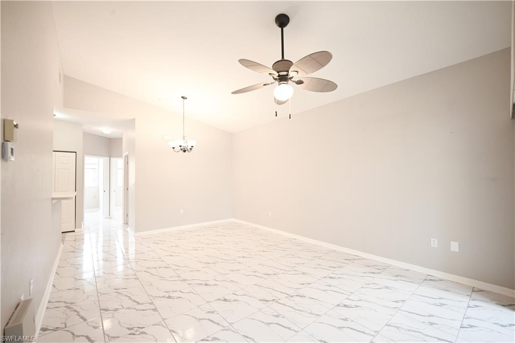 Vaulted ceilings with a ceiling fan, recessed lighting, and large floor tile throughout