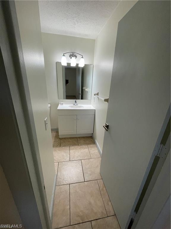Bathroom featuring a vanity with integrated sink, wall-mounted mirror, and vanity light fixture