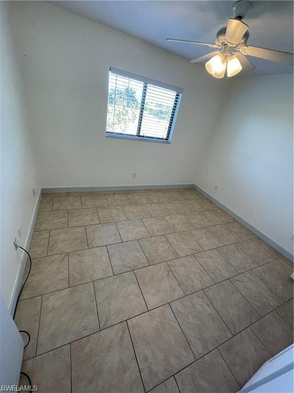 Vaulted ceiling, ceiling fan with integrated lighting, tiled flooring, window with blinds