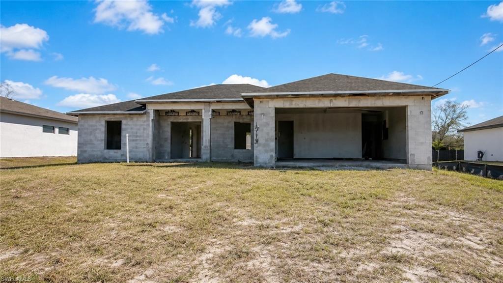 Single-story construction with a shingle roof and a two-car garage