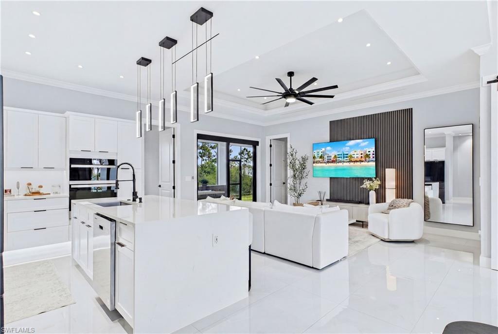 Modern kitchen with white cabinetry and integrated stainless steel appliances