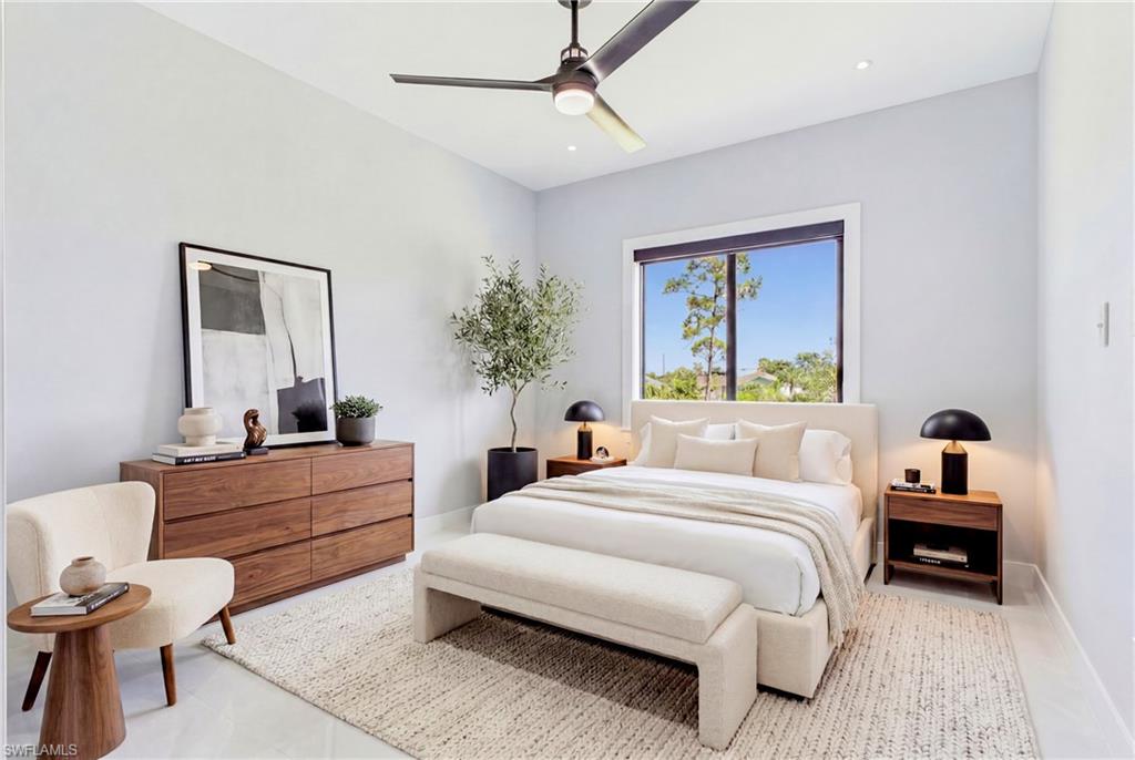 Recessed lighting, ceiling fan, and large window with dark trim