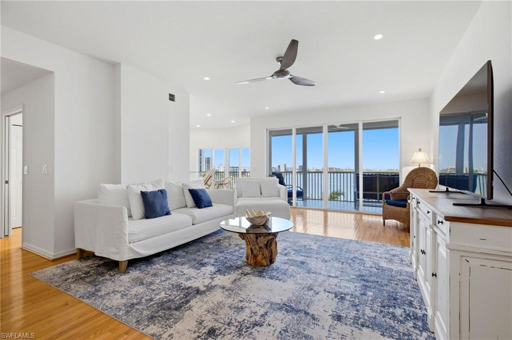 Elegant wood flooring flows throughout the residence, while a dramatic wall of sliding glass doors frames breathtaking, panoramic views of Estero Bay.