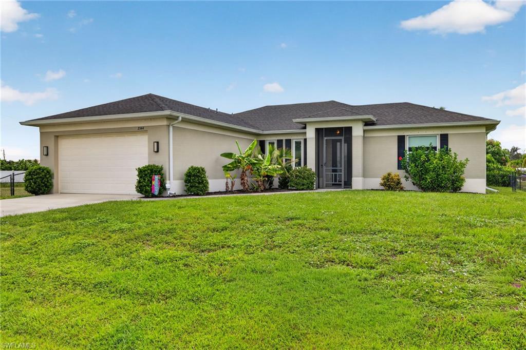 Contemporary single-story residence with a two-car garage, screened front entry, and black window shutters