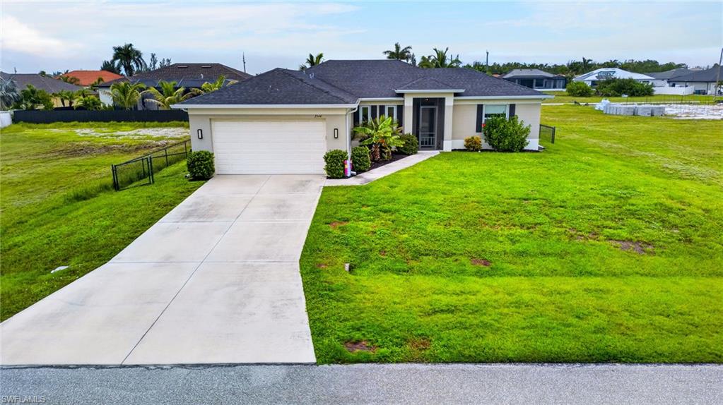 Single-story residence featuring a two-car garage, concrete driveway, and a covered entry