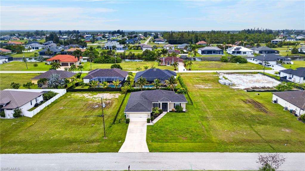 Single-story residence with a concrete driveway, two-car garage, and a lush green lawn