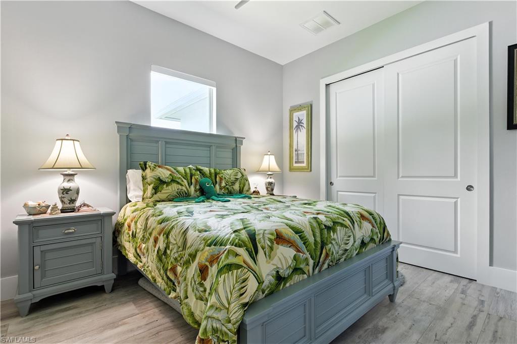 Bedroom featuring light wood-style floors and a closet