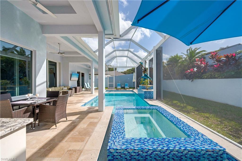 View of pool featuring a sunroom, outdoor lounge area, a patio area, a lanai, and outdoor dining area