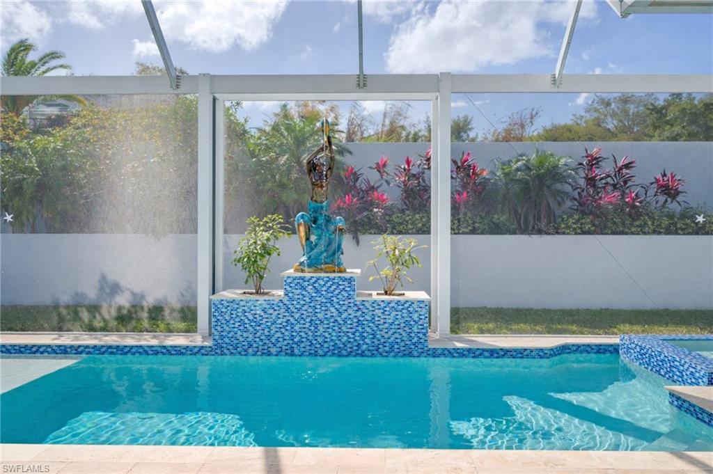 View of pool with a sunroom and glass enclosure