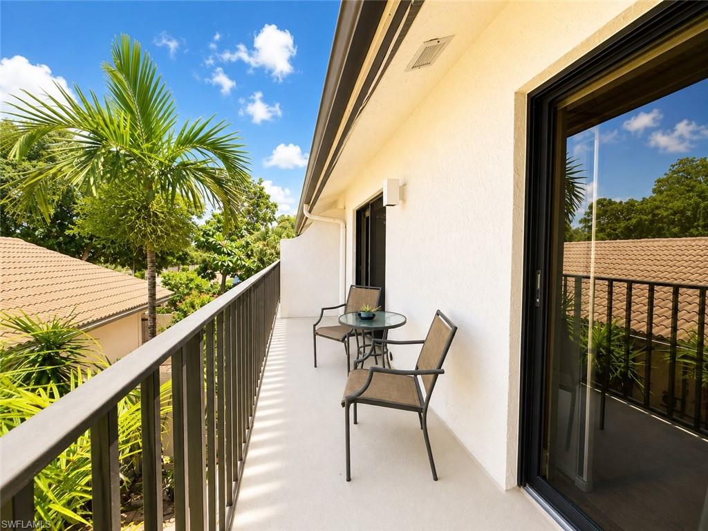 Balcony with metal railing and wall-mounted lighting