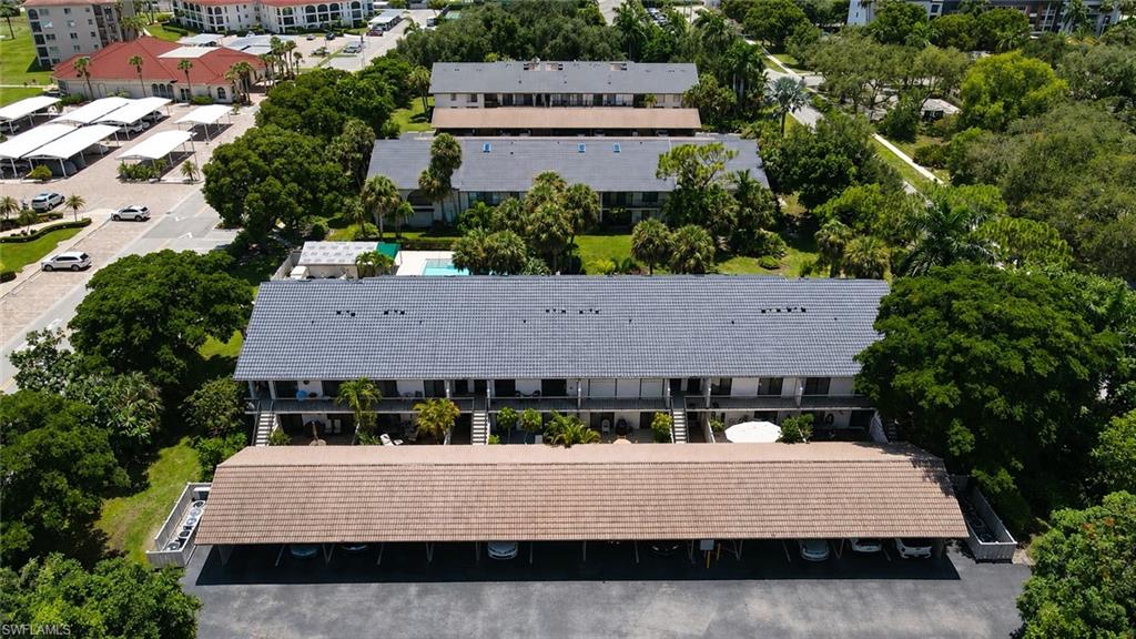 Multi-level residential buildings featuring dark shingle roofs and covered parking structures