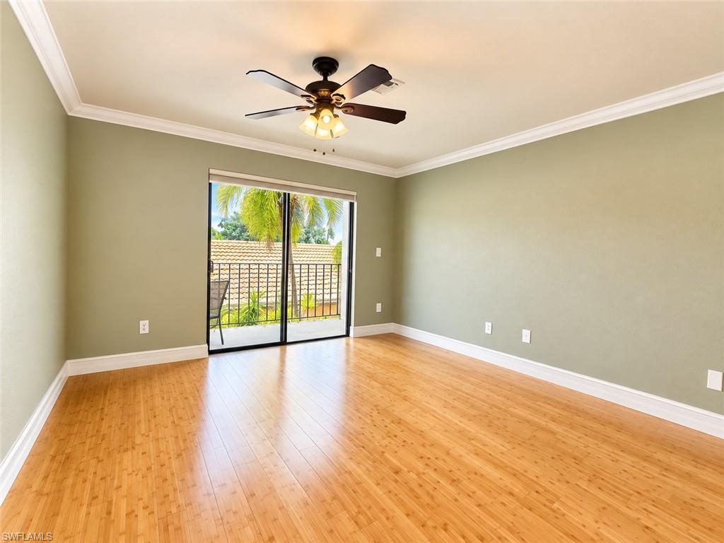 Wood-finish flooring, crown molding, built-in ceiling fan with light, and bi-fold closet doors