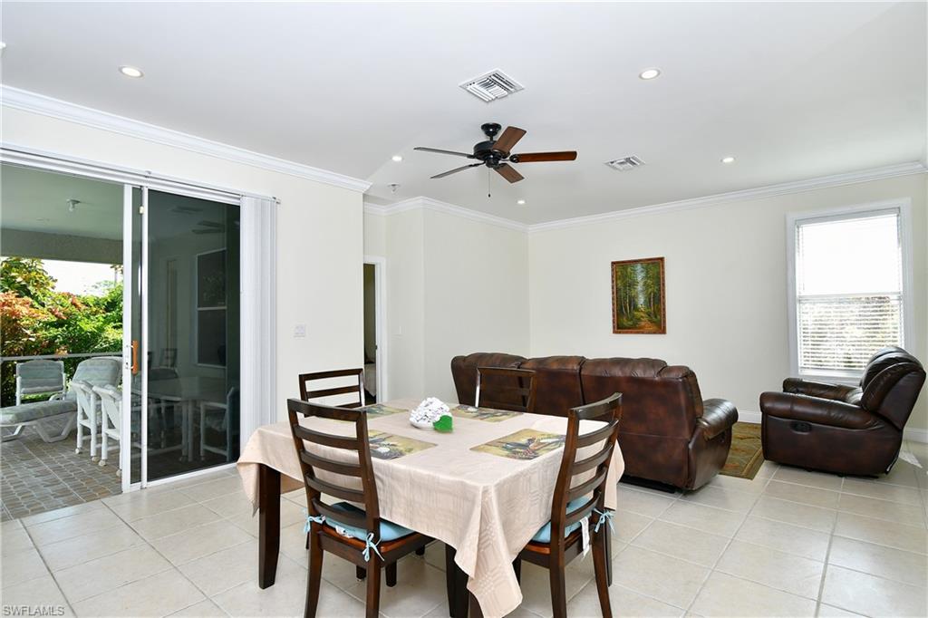 Spacious interior featuring crown molding, recessed lighting, and a ceiling fan