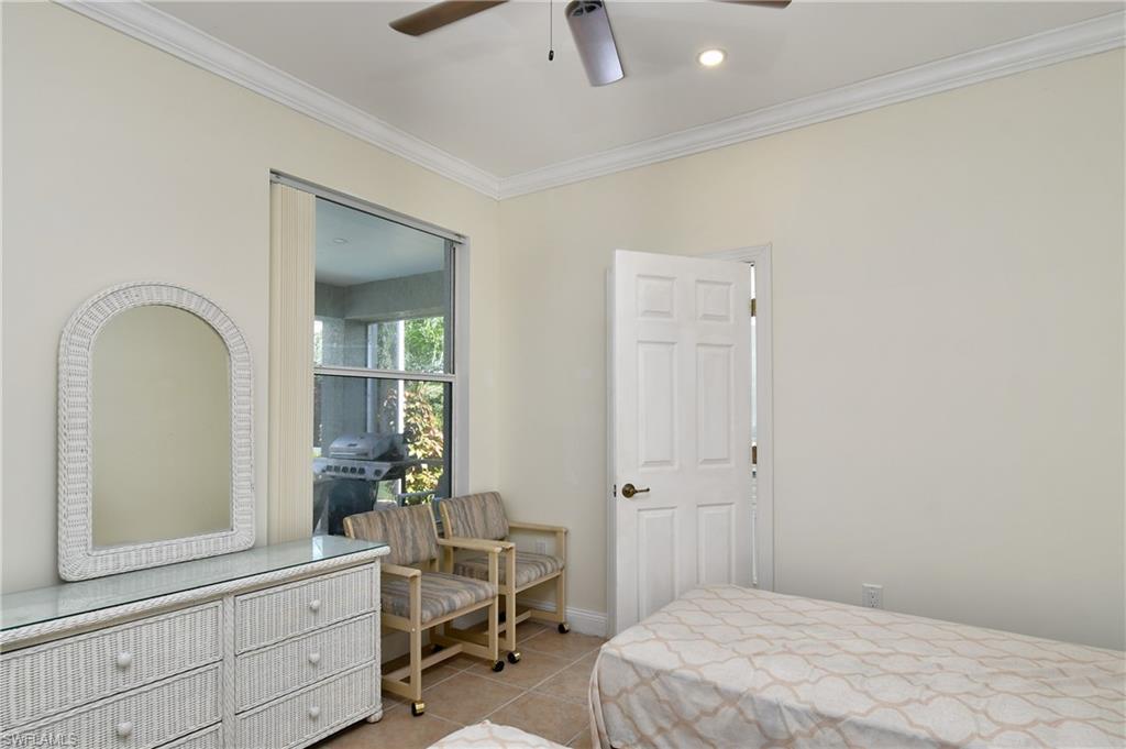 Bright bedroom featuring neutral wall finishes, ceiling fan with recessed lighting, and wood-finish flooring