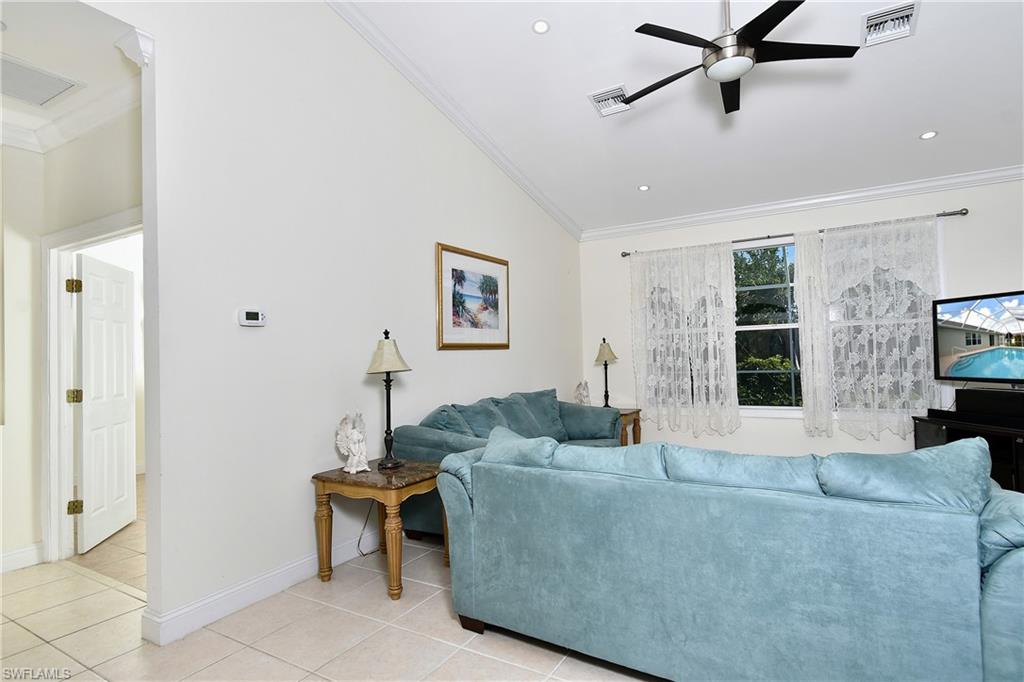 Vaulted ceiling, ceiling fan, recessed lighting, tile flooring, crown molding