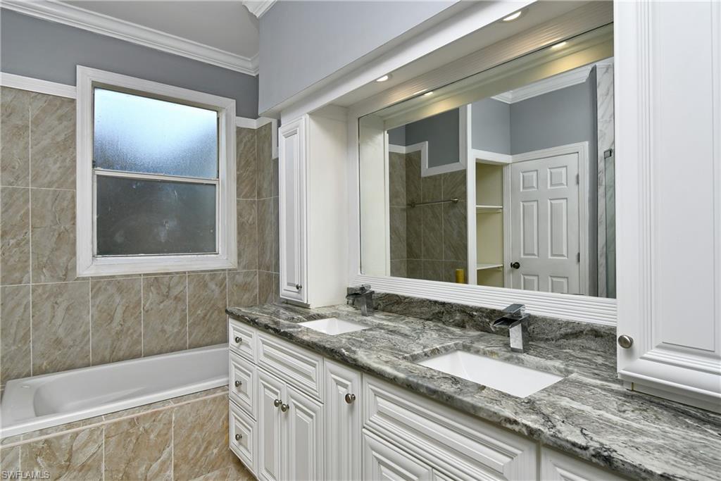 Dual vanity with grey patterned countertop and integrated sinks