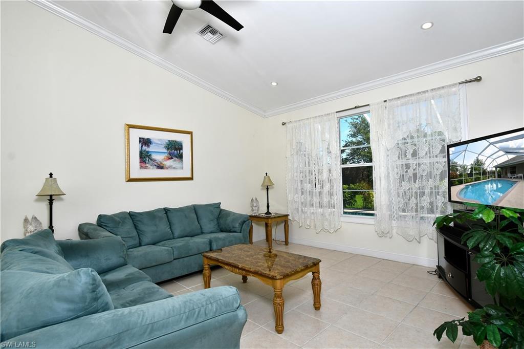 Recessed ceiling lighting, crown molding, and tiled flooring
