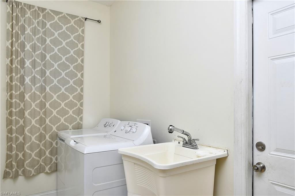 Laundry area featuring a utility sink with a chrome faucet