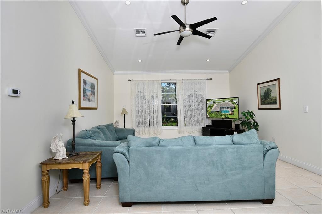 Vaulted ceiling with recessed lighting and a contemporary ceiling fan