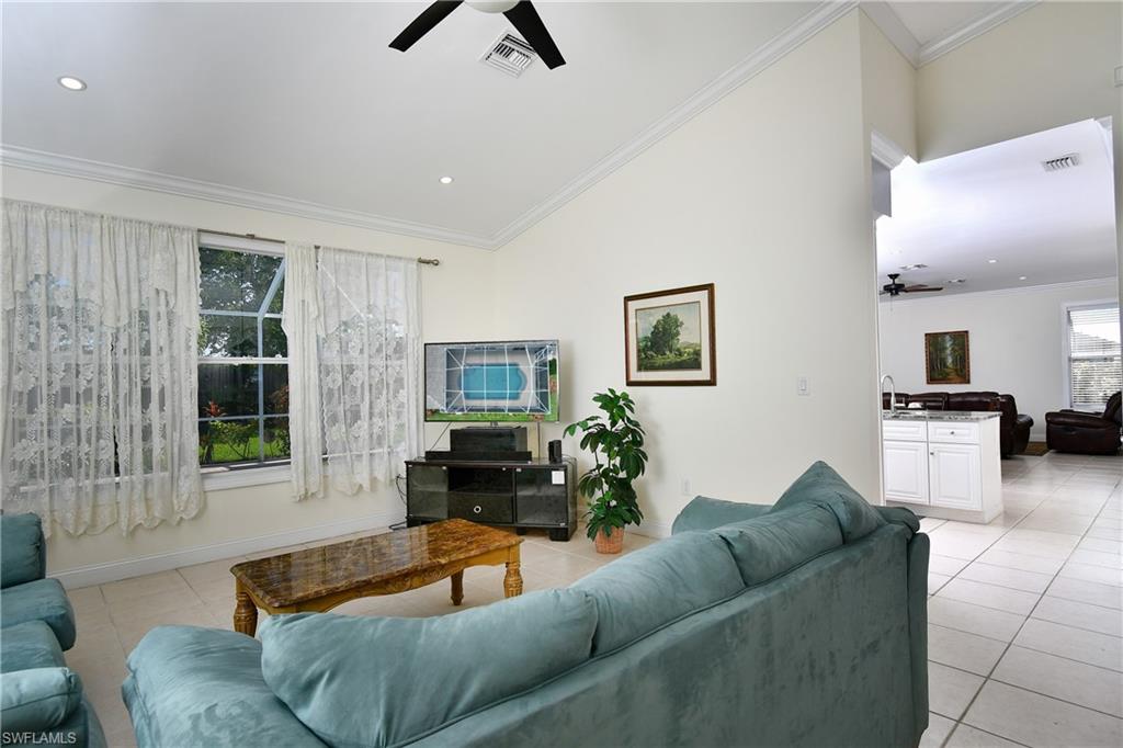 Vaulted ceiling with recessed lighting and crown molding