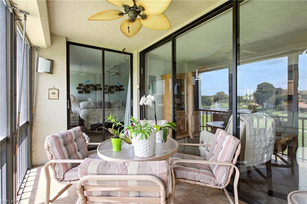 Screened patio featuring a ceiling fan, outdoor wall sconce, and sliding glass doors