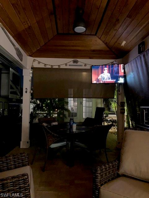 Dining room featuring vaulted ceiling and wooden ceiling