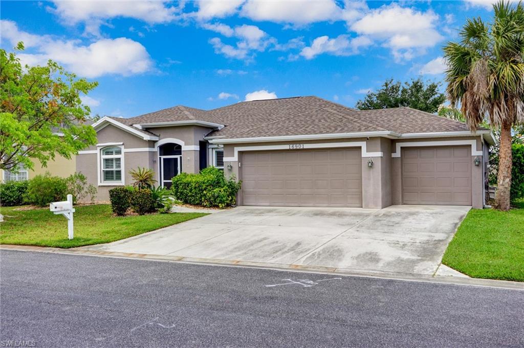 Stucco exterior with a shingle roof, integrated two-car and one-car garages, and a concrete driveway