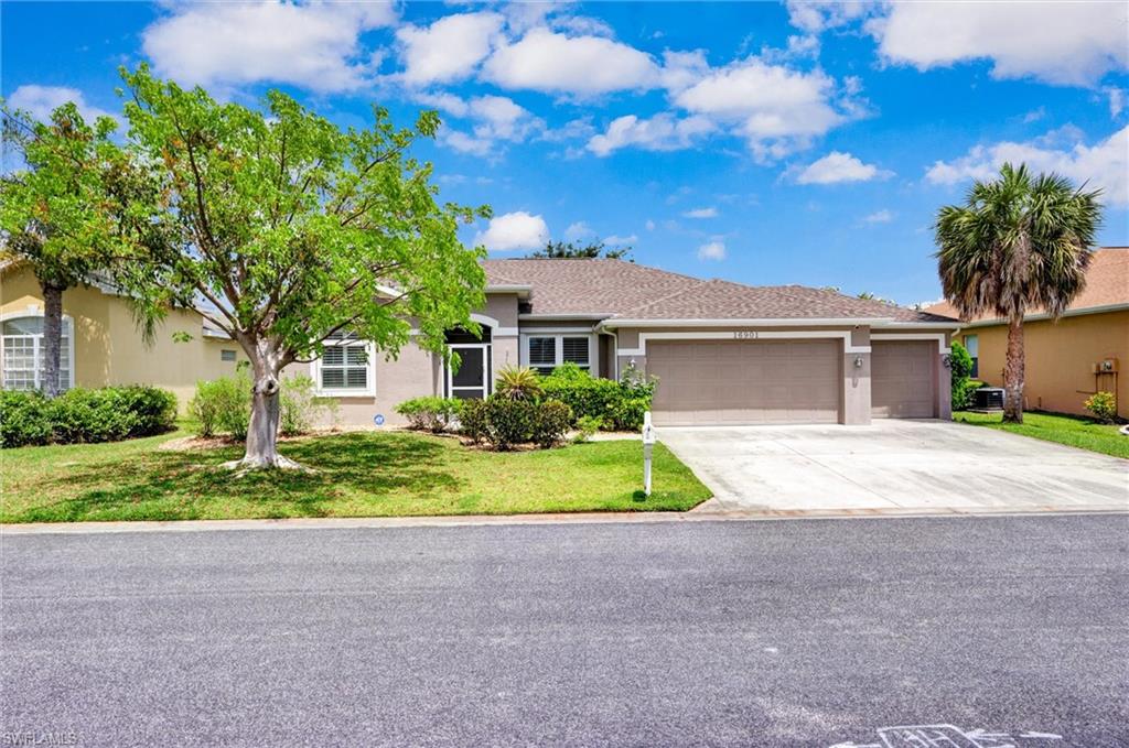 Single-story residence featuring a two-car garage, concrete driveway, and a screened front entry