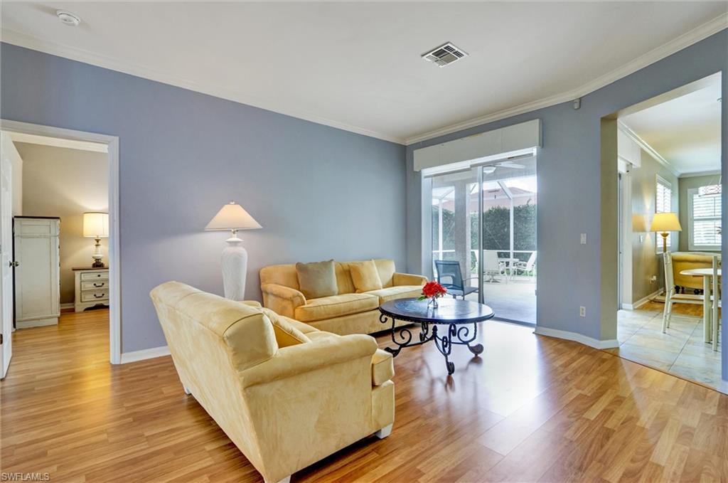Wood-finish flooring, sliding glass doors, and crown molding