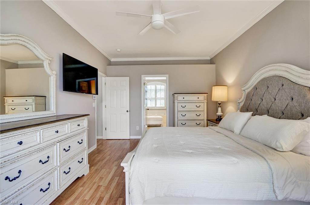 Wood-finish flooring, crown molding, ceiling fan, and recessed lighting