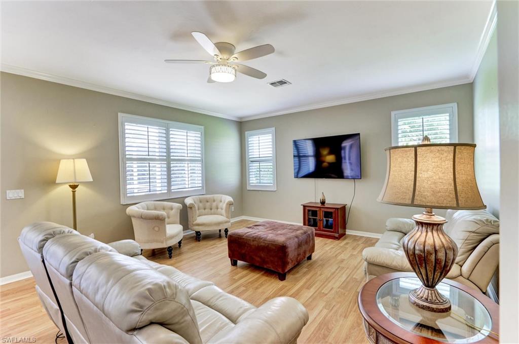 Wood-finish flooring throughout, complemented by crown molding and recessed lighting
