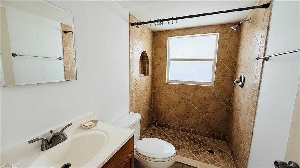 Tiled shower enclosure with built-in niche and window